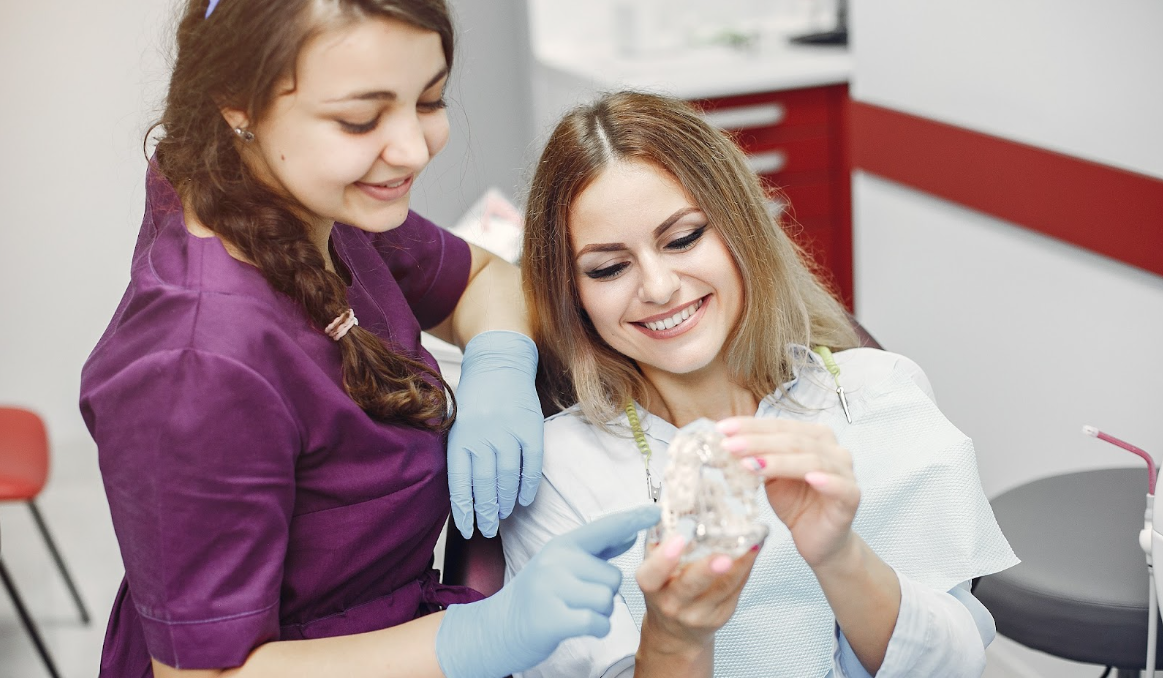 A beautiful girl discussing the Invisalign process with her dentist