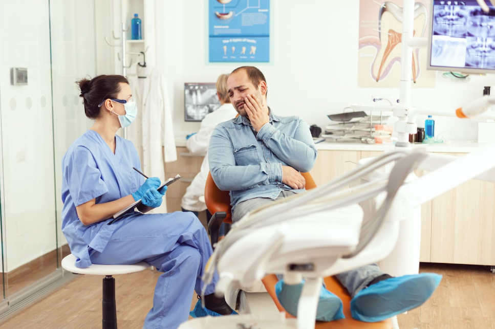 A dentist examining patient with dental problem due to mail-order aligners