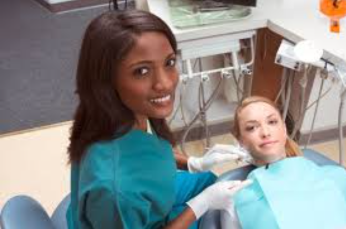 A women getting a dental procedure at her dentist’s clinic