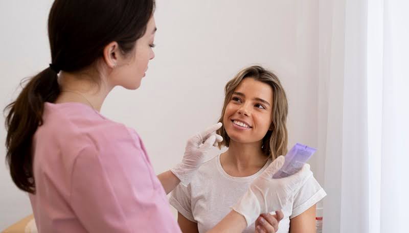A medium shot of a woman getting lip filler