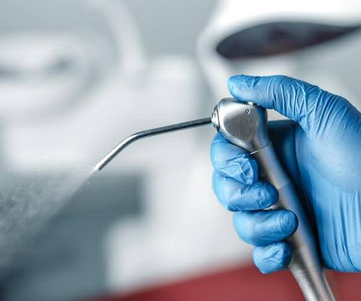 A water sprayer getting a patient ready for ozone treatment for teeth