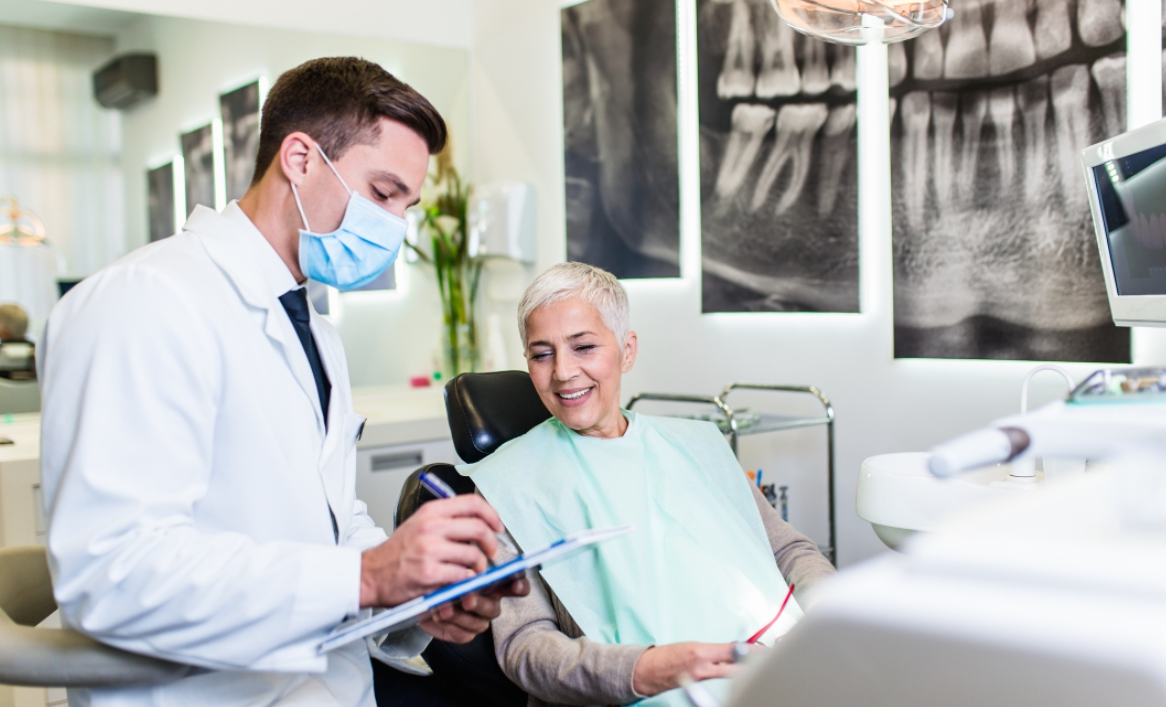 Dentist consulting her old patient about the dental process