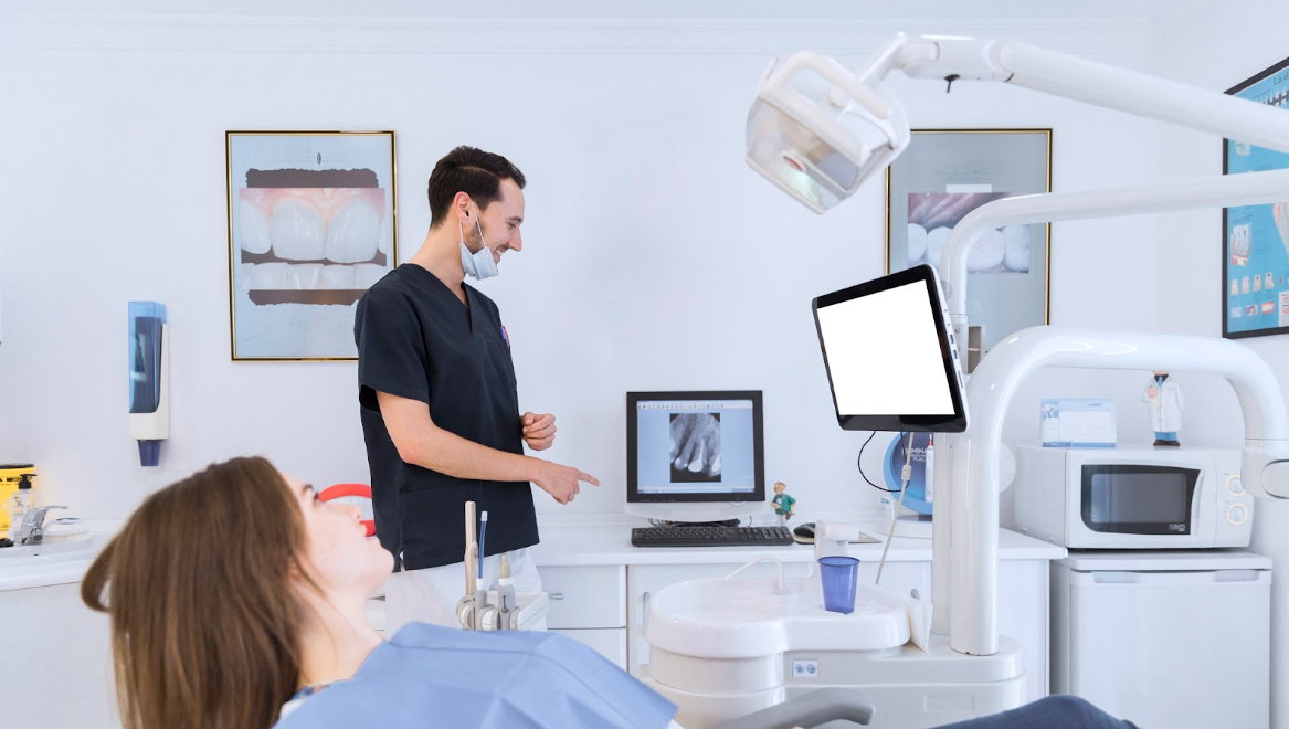 Dentist explaining teeth x ray to his patient