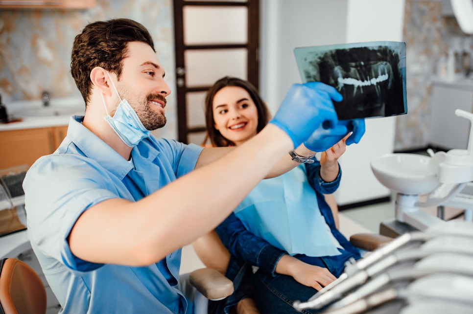 Dentistry showing his female patient the treatment process
