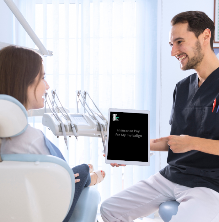 Happy dentist pointing to insurance plan with his female patient