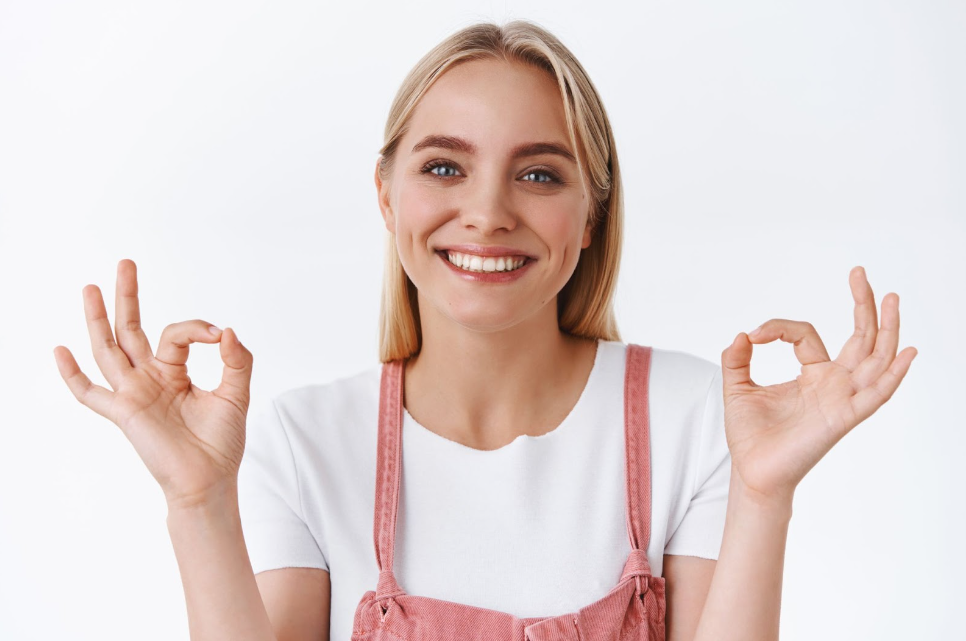 Satisfied blond woman smiling due to perfect results of her dental procedure