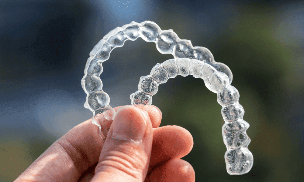A Man Holding Invisalign Aligners for sleep apnea treatment in the Air With Fingers
A Man Holding Invisalign Aligners for sleep apnea treatment in the Air With Fingers