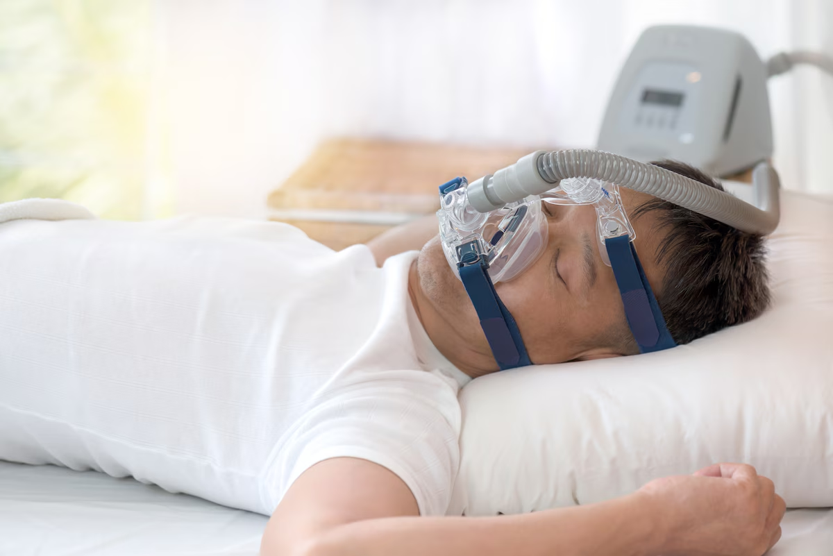 A Man Using a Sleep Apnea Machine to Treat Sleep Apnea
