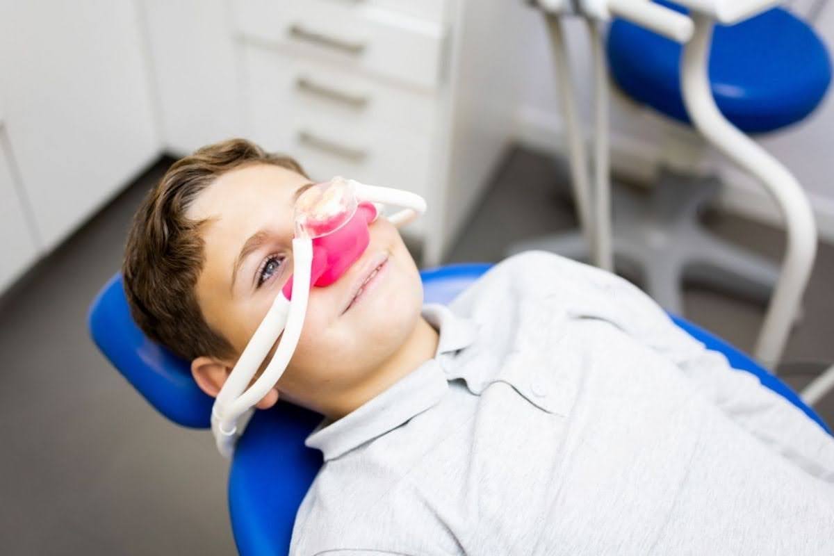   A happy child experiencing comfort through IV sedation dentistry near him for a stress-free procedure
