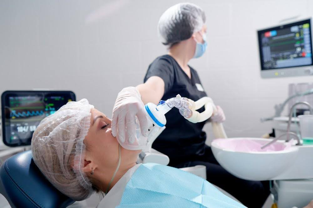 A patient using laughing gas as her oral sedation dentistry A patient using laughing gas as her oral sedation dentistry