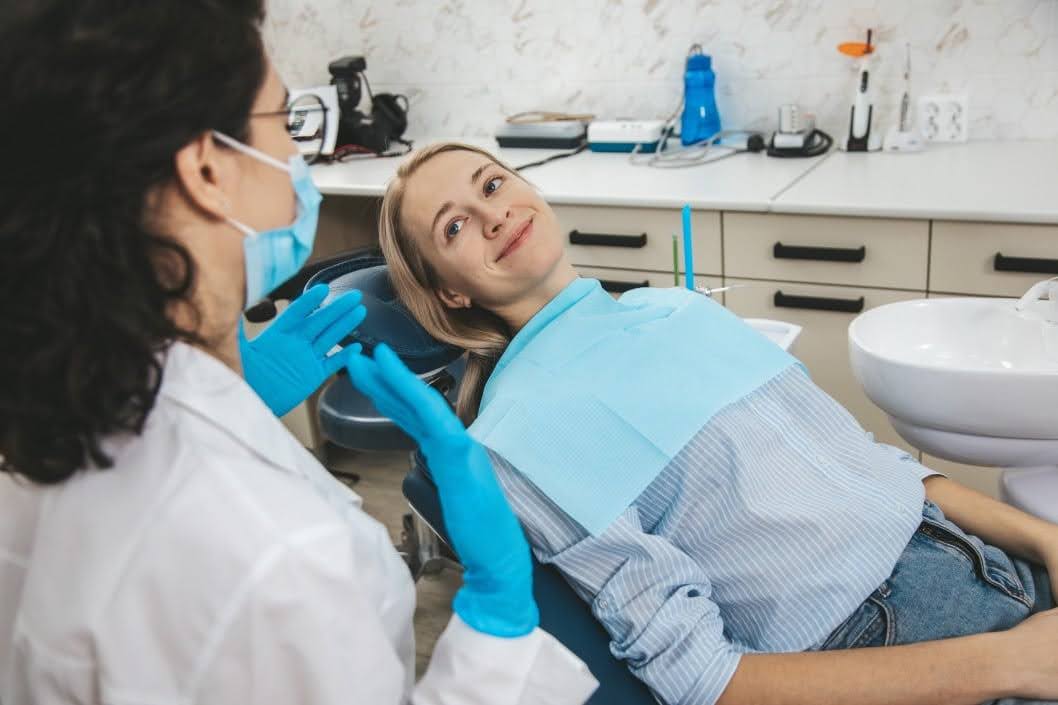 A Biologic Dentistry Specialist Explaining Her Dental Procedure to a Young Lady
