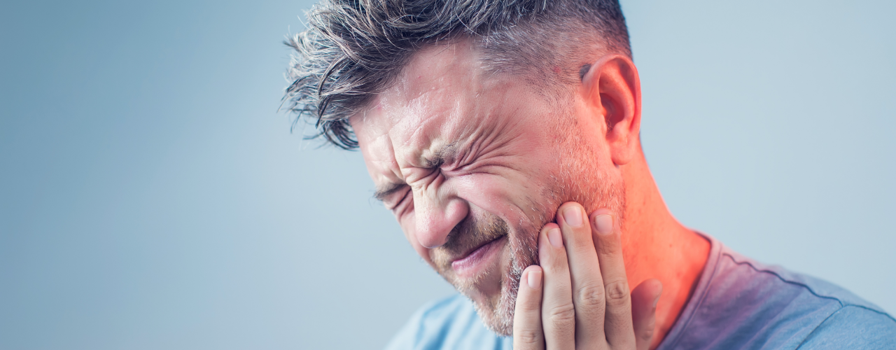   A Man Feeling Severe Jaw Pain
