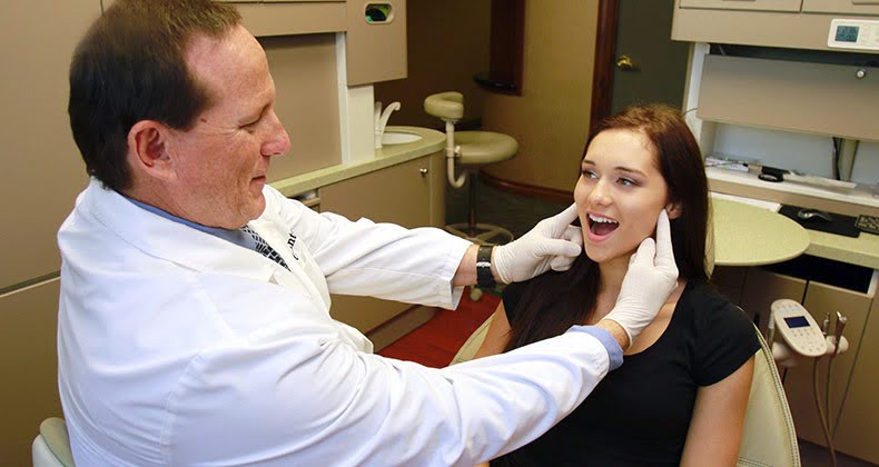  A Dentist Checking Jaw Pain in joints of A girl in the Clinic