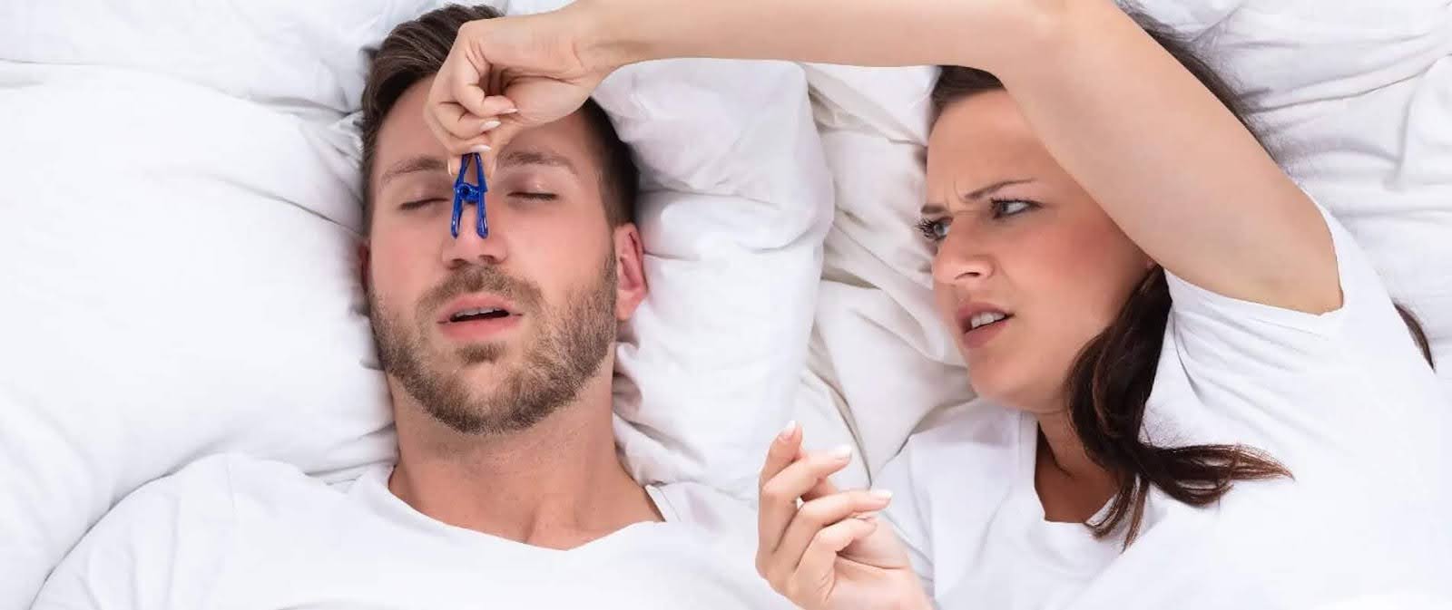   Annoyed Woman Trying to Close the Nostrils of Her Partner to Stop Snoring Causes