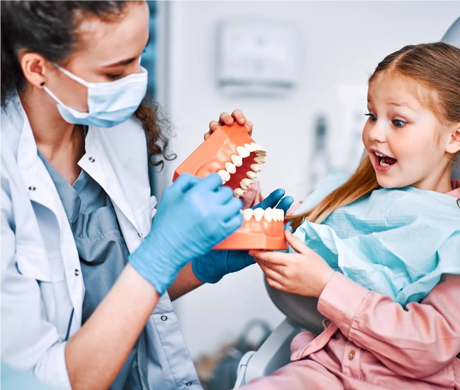  a doctor guiding a girl about gentle tooth extraction for children