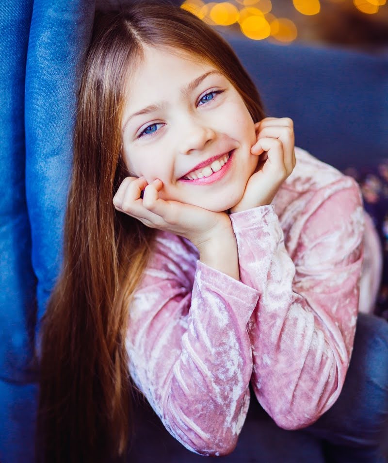  A beautiful, cute little girl smiling at a dentist's office to check for children's cavities