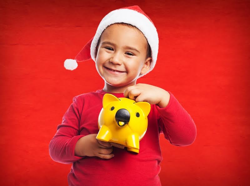  An adorable child who has a zirconium crown, saving money, putting it in a piggy bank