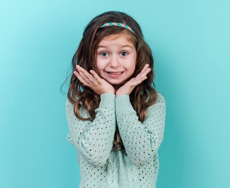  A little adorable, amazed girl waiting for her mercury-free fillings